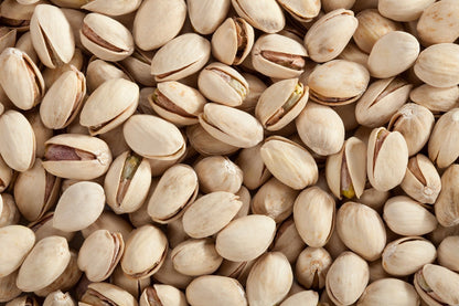 Roasted and salted pistachios from Whole Food Earth in a bowl, showing the green nuts with salt crystals on their shells.