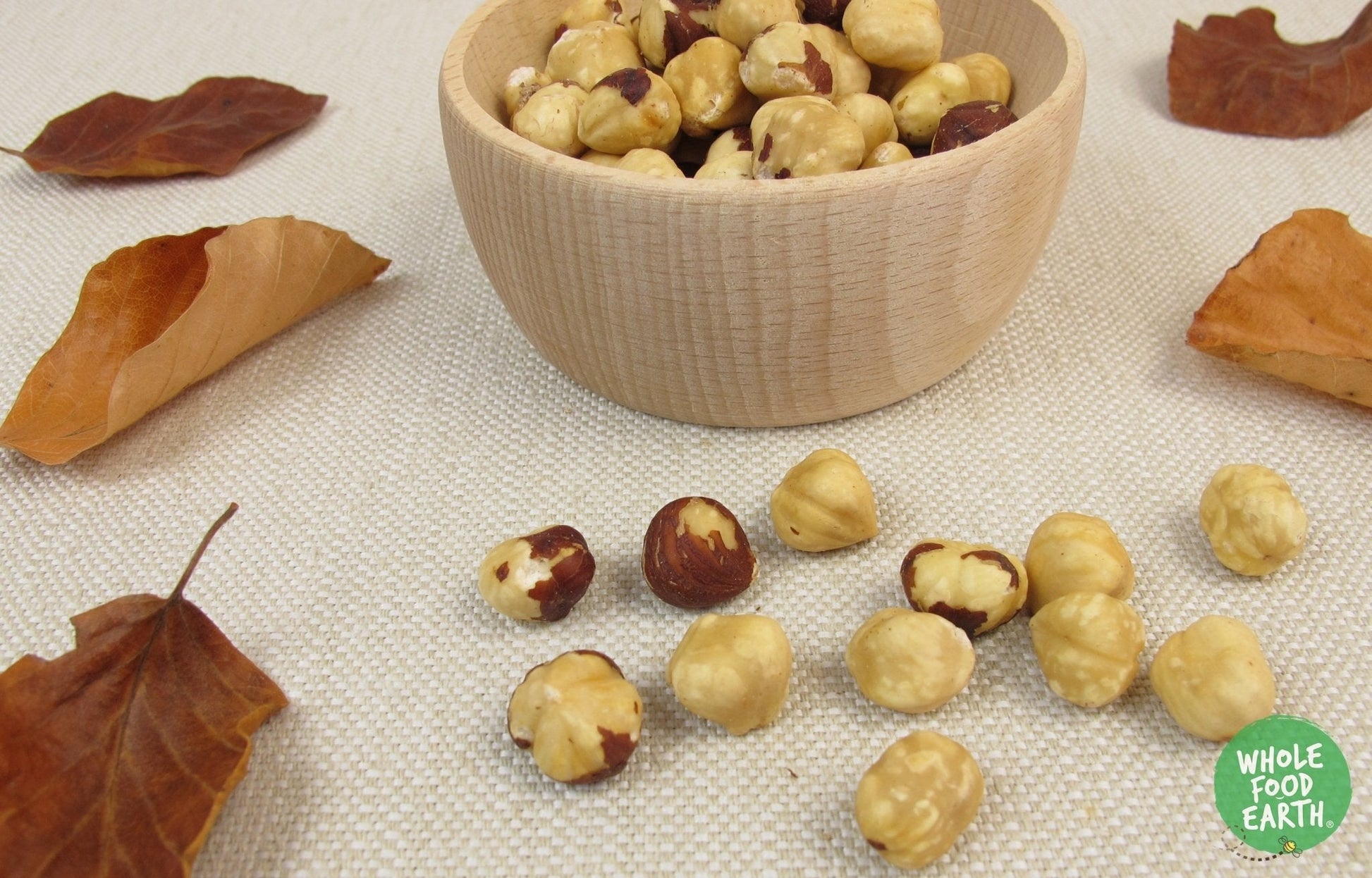 Roasted Whole Hazel Nuts from Whole Food Earth, GMO-free, vegan, dairy-free, no added sugar, in a clear bowl.