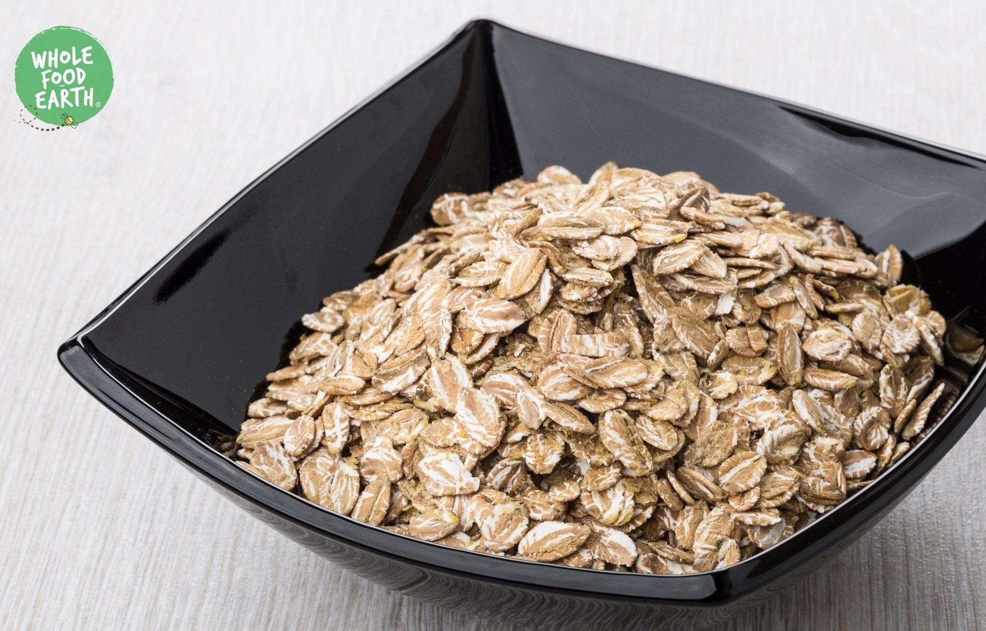 Whole Food Earth rye flakes in a bowl, showcasing GMO-free, vegan, dairy-free, and no-added-sugar speciality cereal