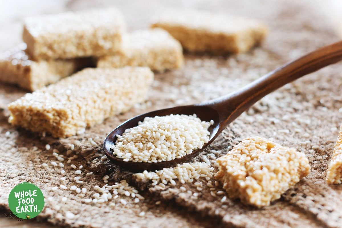 Hulled sesame seeds from Whole Food Earth, GMO-free, vegan, dairy-free, and no added sugar, shown in a close-up image.