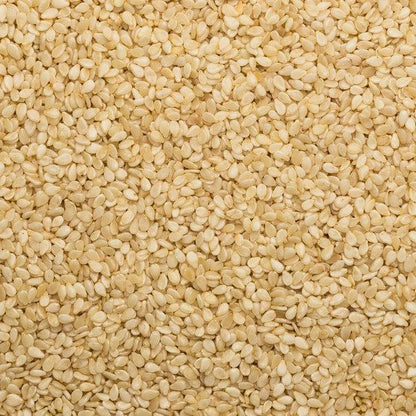 Hulled sesame seeds from Whole Food Earth, vegan, dairy-free, GMO-free, and no added sugar in a clear view of the seeds.