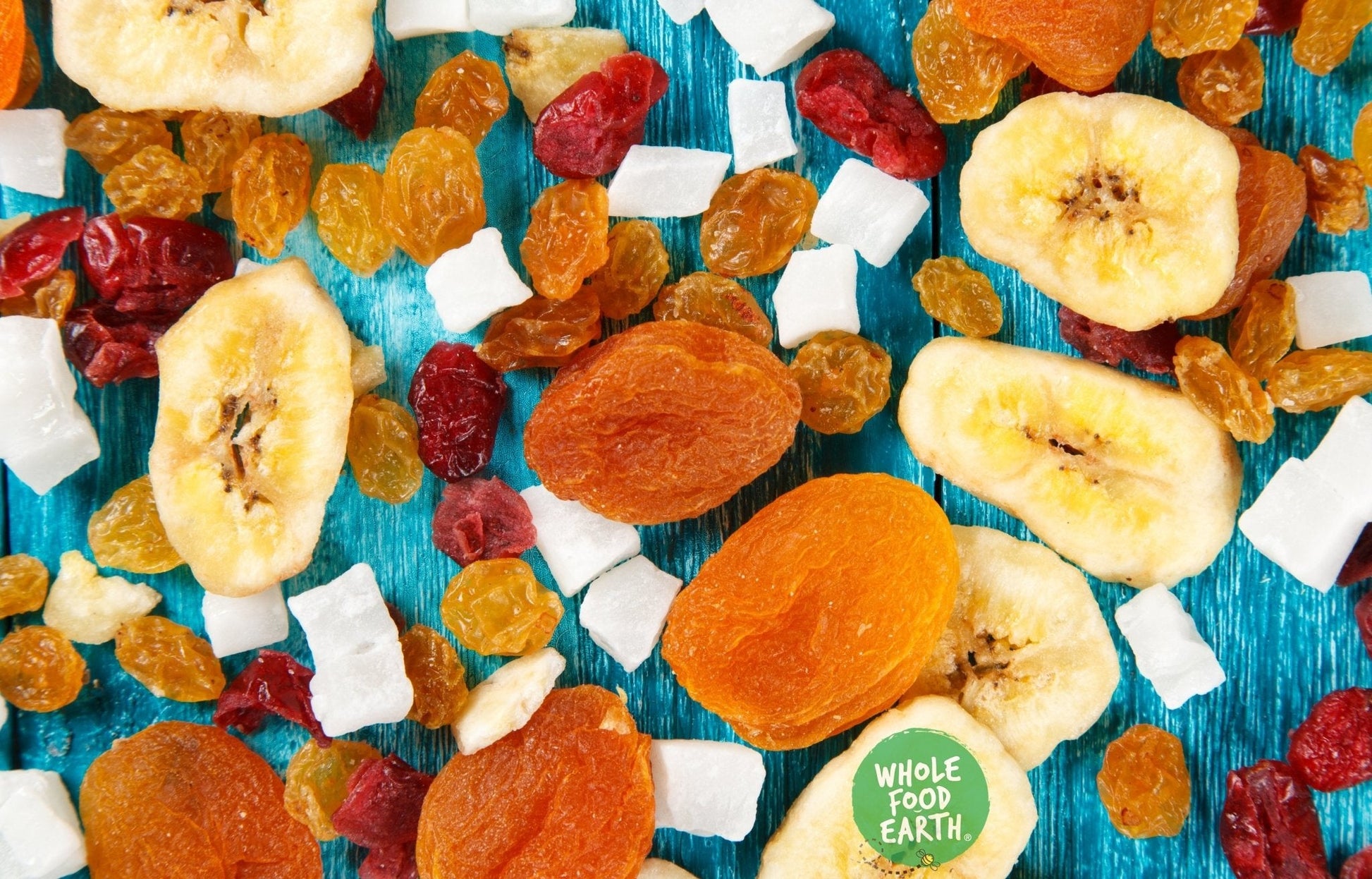 Assorted dried fruits and nuts in Sunset Mix by Whole Food Earth, vegan, dairy-free, GMO-free specialty blend in a bowl.