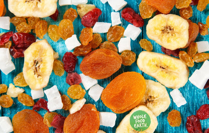 Assorted dried fruits and nuts in Sunset Mix by Whole Food Earth, vegan, dairy-free, GMO-free specialty blend in a bowl.