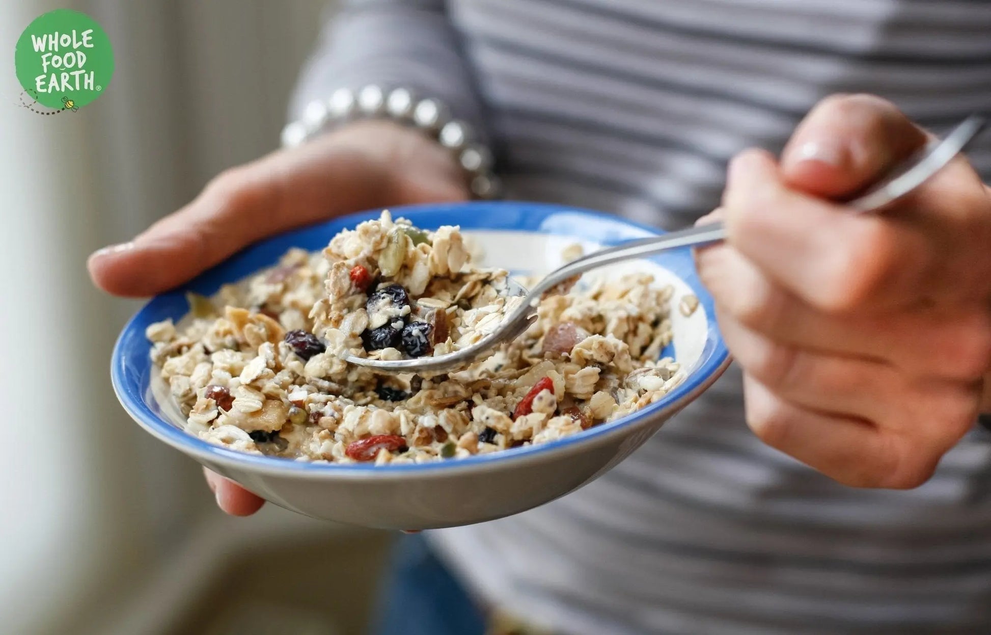 Whole Food Earth Totally Fruity Gluten-Free Muesli cereal with dried fruit, seeds, and gluten-free flakes in a bowl.