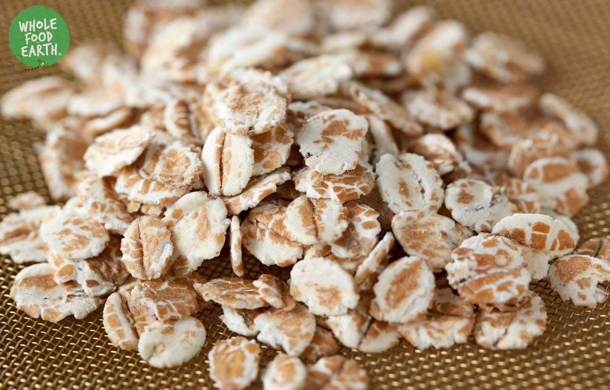 Whole Food Earth Wheat Flakes cereal in a bowl, showcasing GMO-free, vegan, dairy-free, no added sugar wheat flakes.