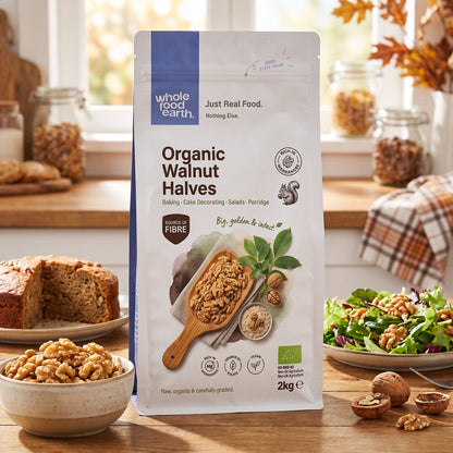 Organic Walnut Halves from Whole Food Earth shown in a bowl with some scattered walnuts, highlighting fresh, natural nuts and seeds.