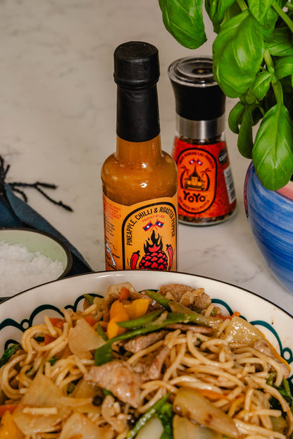 YoYo Laos Sauce Pineapple Chilli & Roasted Pepper Signature Sauce in a jar with visible chunks of pineapple, chili, and roasted peppers