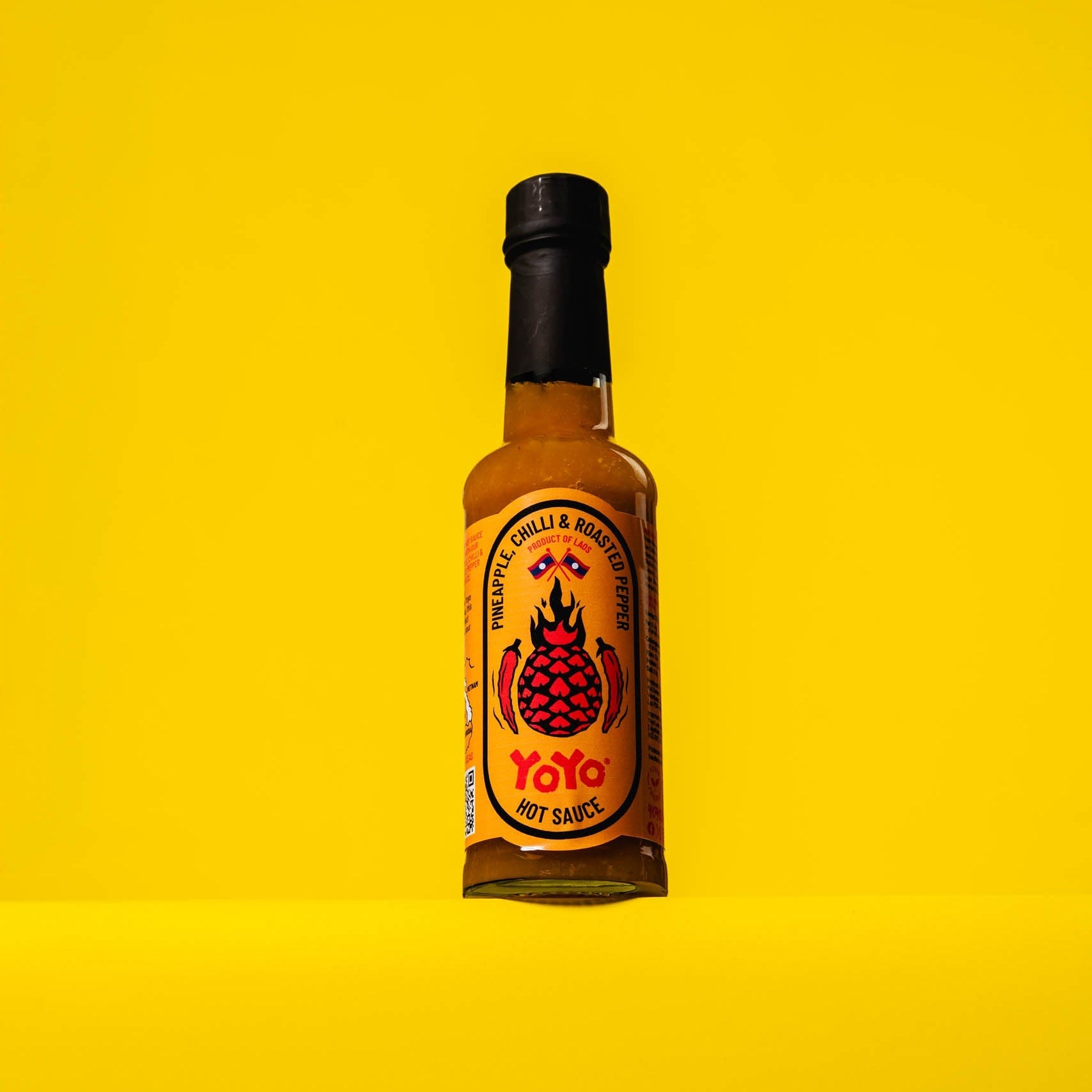 YoYo Laos Sauce Pineapple Chilli & Roasted Pepper Signature Sauce in a jar with vibrant ingredients visible.