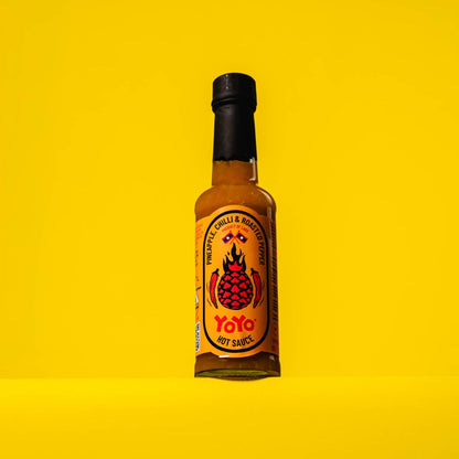 YoYo Laos Sauce Pineapple Chilli & Roasted Pepper Signature Sauce in a jar with vibrant ingredients visible.